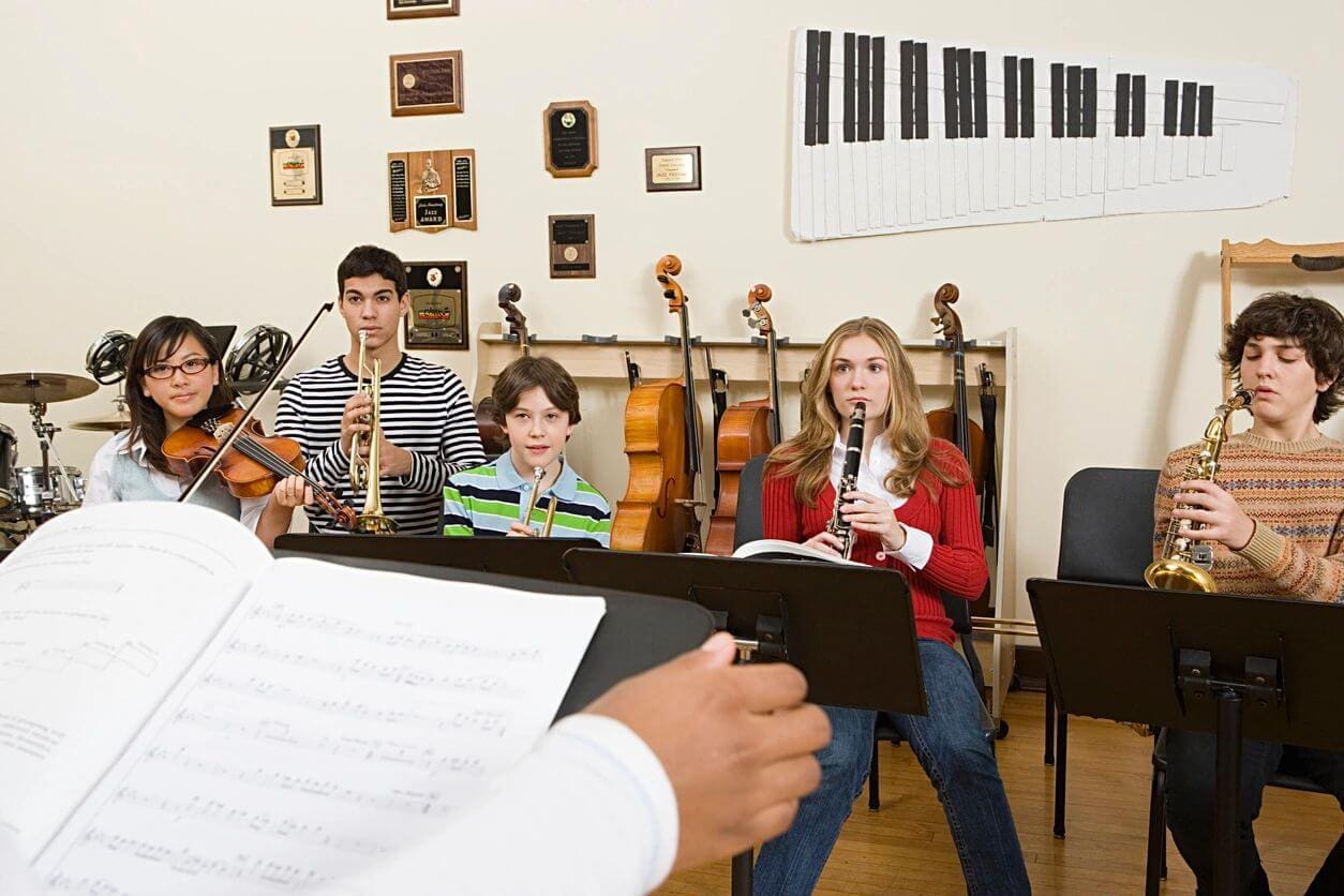 A group of people in a room with musical instruments.